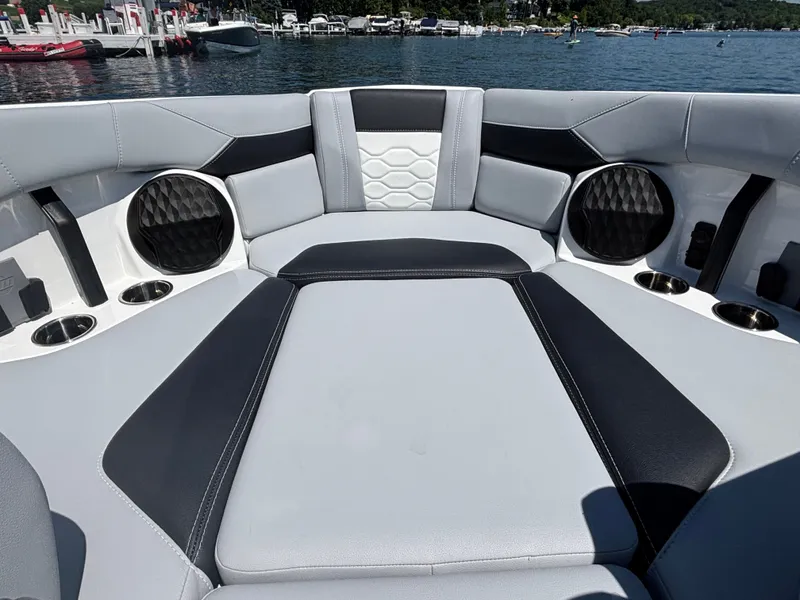 Slide: The Image of The image shows the bow area of a Malibu Wakesetter 23 LSV with luxurious upholstery and cup holders. - 882