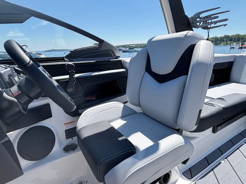 Slide: The Image of The image shows the helm of a Malibu Wakesetter 23 LSV with modern seating and steering wheel. - 892