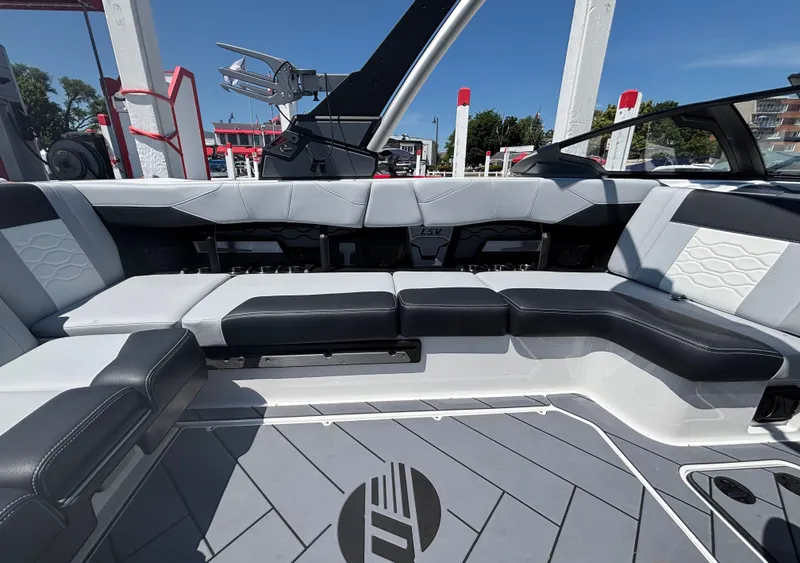 Slide: The Image of The image shows the interior of a Malibu Wakesetter 23 LSV with modern, cushioned seating. - 885
