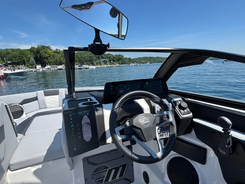 Slide: The Image of The cockpit of a 2026 Malibu Wakesetter 23 LSV with a modern steering wheel and touchscreen displays. - 888