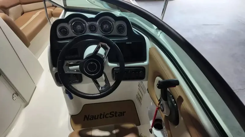 Slide: The Image of The image shows the cockpit of a 2023 NauticStar 243 DC boat with a modern helm. - 38
