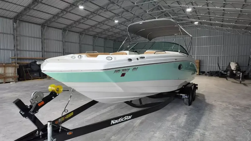 Slide: The Image of A 2023 NauticStar 243 DC boat in a storage facility. - 10
