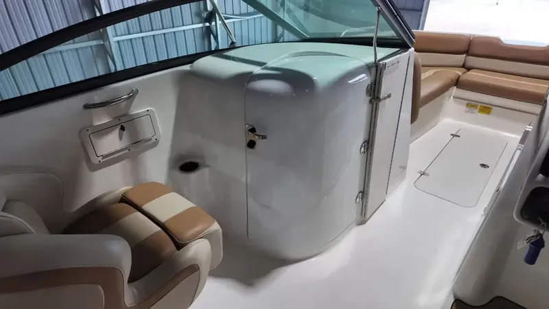 Slide: The Image of The image shows the interior of a NauticStar 243 DC boat with beige seating and a helm station. - 43