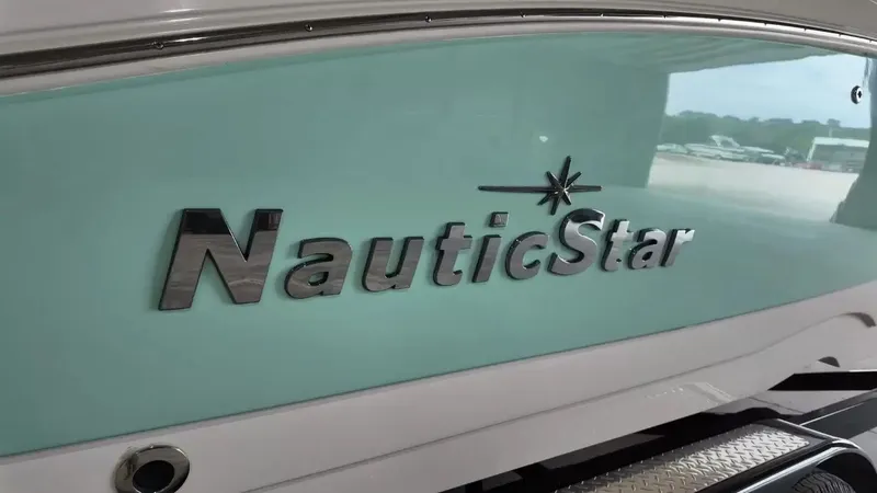 Slide: The Image of Close-up of the NauticStar logo on a 2023 model 243 DC boat. - 2