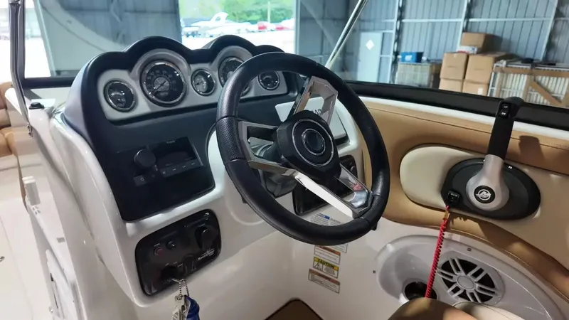 Slide: The Image of The image shows the helm of a 2023 NauticStar 243 DC boat with modern instruments. - 34