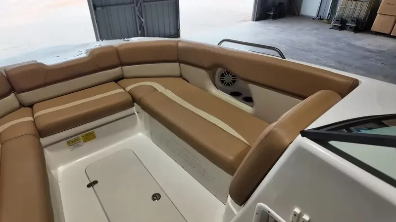 Slide: The Image of The image shows the interior of a 2023 NauticStar 243 DC boat with beige upholstery. - 17