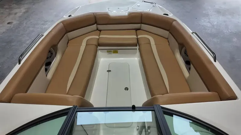 Slide: The Image of The image shows the interior of a 2023 NauticStar 243 DC boat with beige upholstery. - 26
