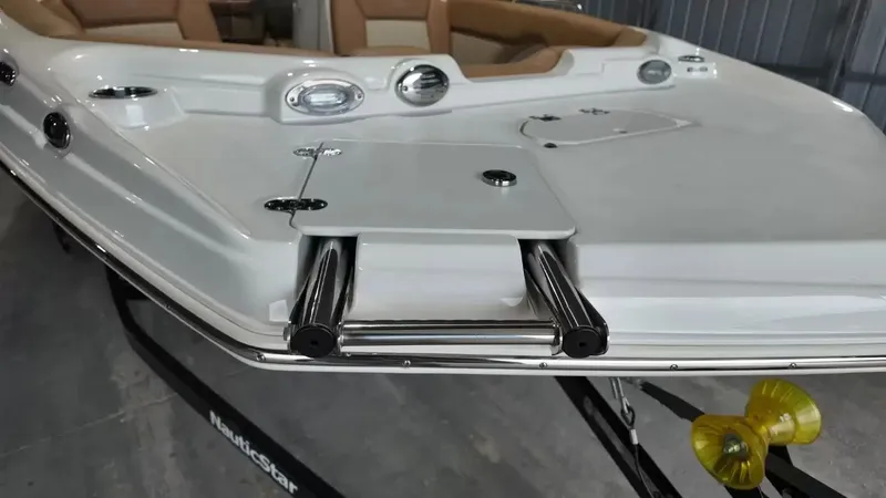 Slide: The Image of The image shows the bow deck of a NauticStar 243 DC boat with a stainless steel ladder. - 14