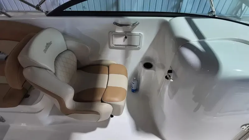 Slide: The Image of A sleek seating area with beige and cream upholstery, next to a small storage compartment. - 47