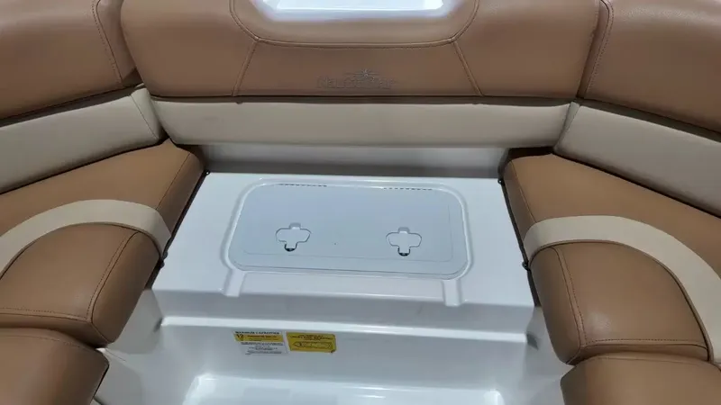 Slide: The Image of Interior view of a 2023 NauticStar 243 DC with beige upholstery and a white table. - 24
