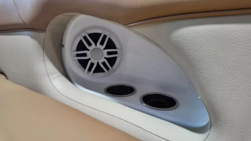 Slide: The Image of Close-up of a speaker and two cup holders in a boat with beige and white upholstery. - 18