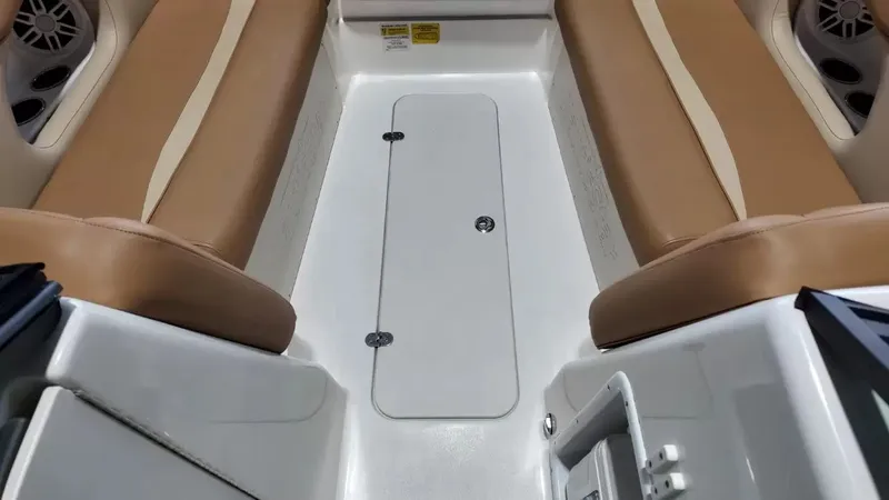 Slide: The Image of Interior view of a NauticStar 243 DC boat with beige seats and a white floor. - 29