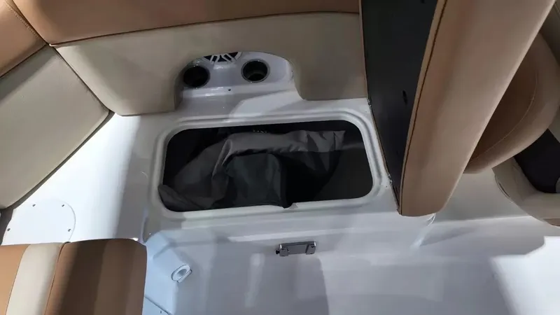 Slide: The Image of Interior of a NauticStar 243 DC featuring storage space and speakers. - 49