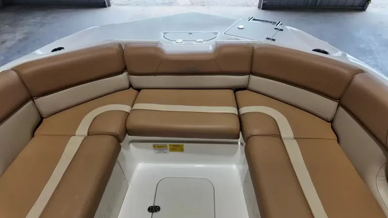 Slide: The Image of The image shows the bow seating area of a 2023 NauticStar 243 DC boat with beige upholstery. - 22