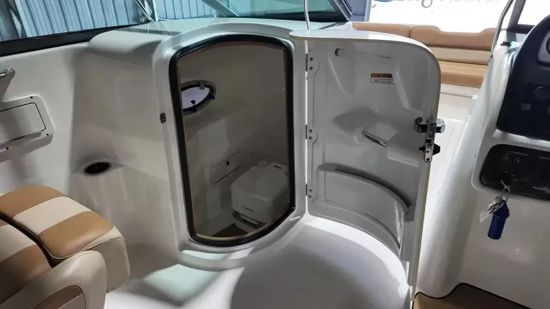 Slide: The Image of The image shows the interior of a NauticStar 243 DC boat with an open cabin door. - 44