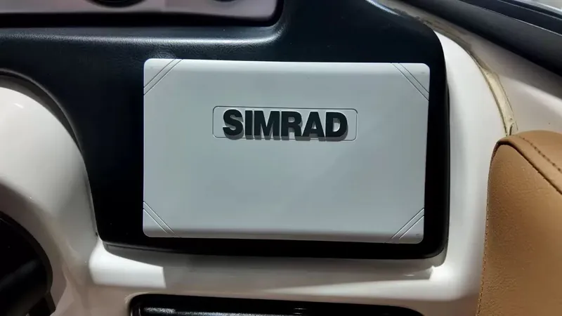 Slide: The Image of The image shows a Simrad navigation system in a 2023 NauticStar 243 DC boat. - 39