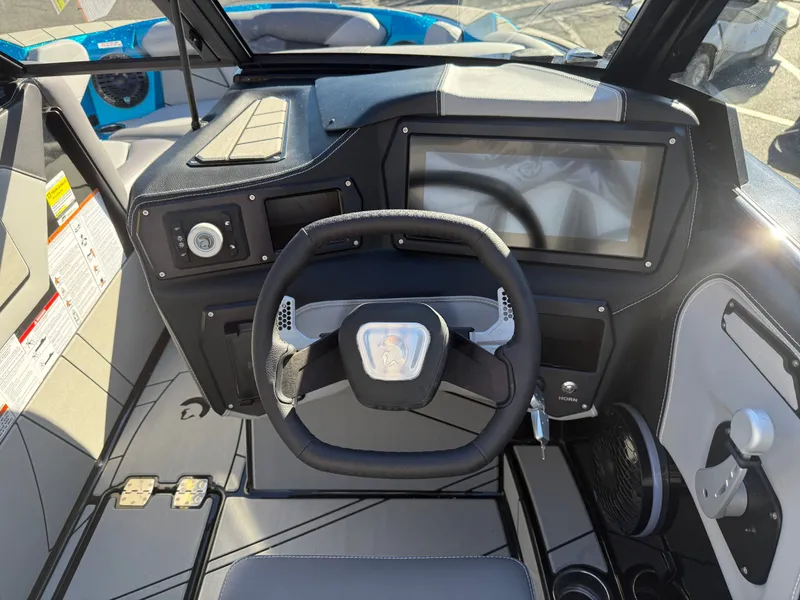 Slide: The Image of The image shows the cockpit of a Centurion Fe22 boat with a modern steering wheel and large display. - 10