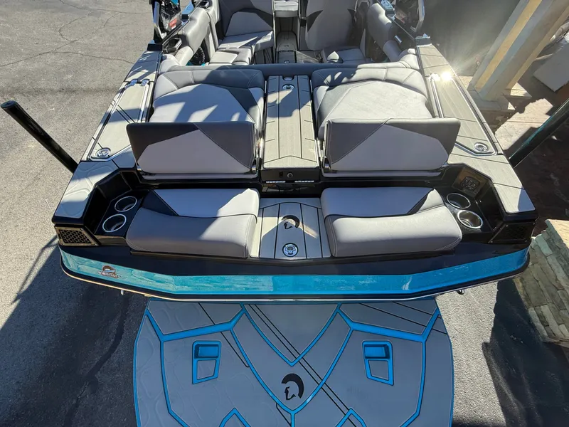 Slide: The Image of The image shows the rear of a Centurion Fe22 boat with gray seating and blue accents. - 15