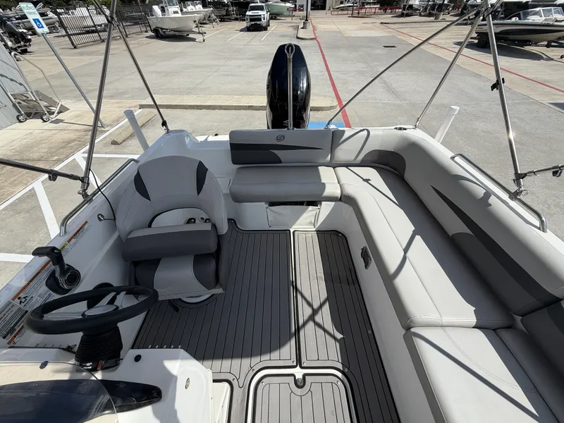 Slide: The Image of The image shows the cockpit of a 2018 Hurricane 201 SS boat with gray seating. - 19