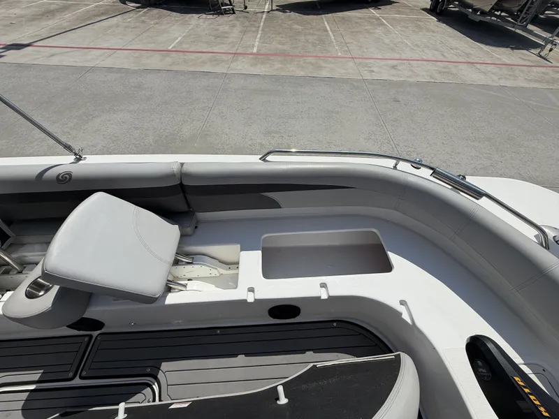 Slide: The Image of The image shows the cockpit of a 2018 Hurricane 201 SS boat with gray seating. - 26