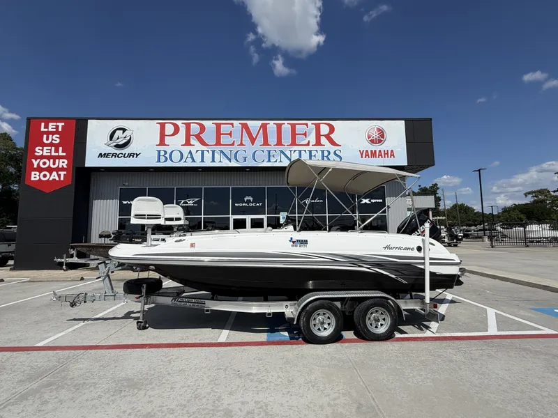The Image of A 2018 Hurricane 201 SS boat on a trailer in front of a boating center. - 1