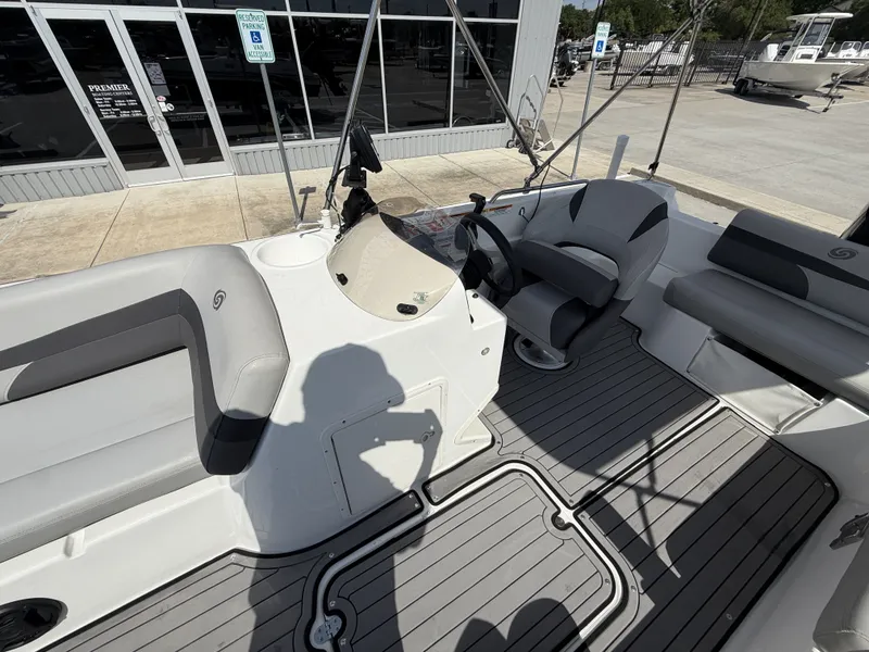 Slide: The Image of The image shows the cockpit of a 2018 Hurricane 201 SS boat with gray seating. - 30