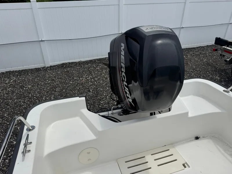 Slide: The Image of A Mercury outboard motor is mounted on the stern of a Boston Whaler 170 Montauk boat. - 4