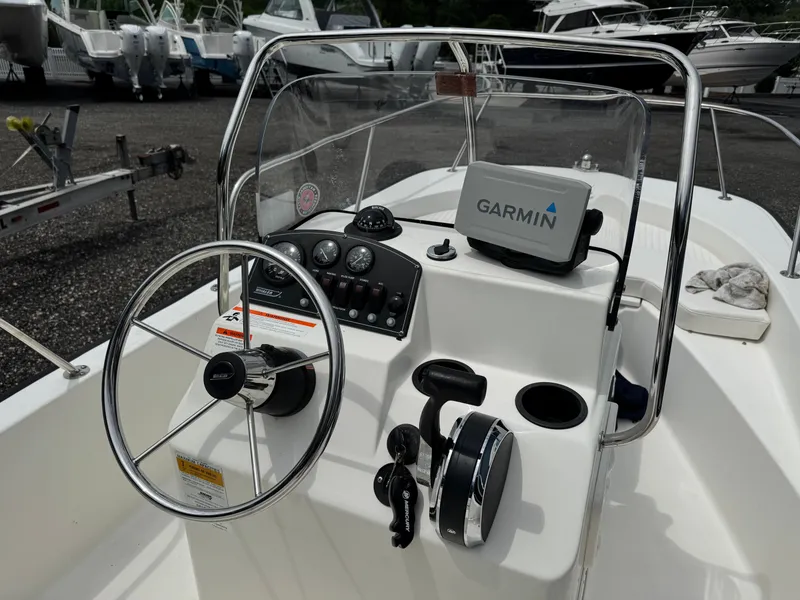 Slide: The Image of The image shows the helm of a 2014 Boston Whaler 170 Montauk with Garmin navigation. - 3