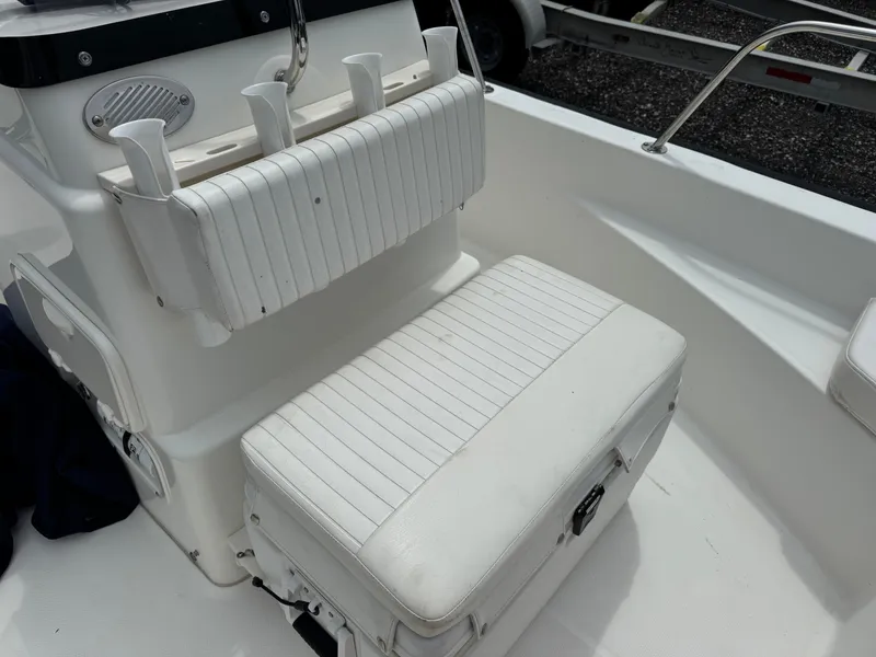 Slide: The Image of The image shows a white bench seat with a backrest on a boat. - 6