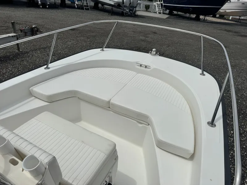 Slide: The Image of The image shows the bow of a 2014 Boston Whaler 170 Montauk boat with white cushions. - 5
