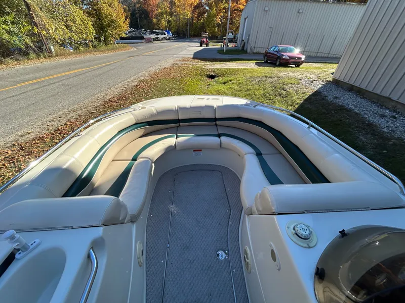 Slide: The Image of The image shows the deck of a 2003 Bennington RL210 boat with cushioned seating. - 8