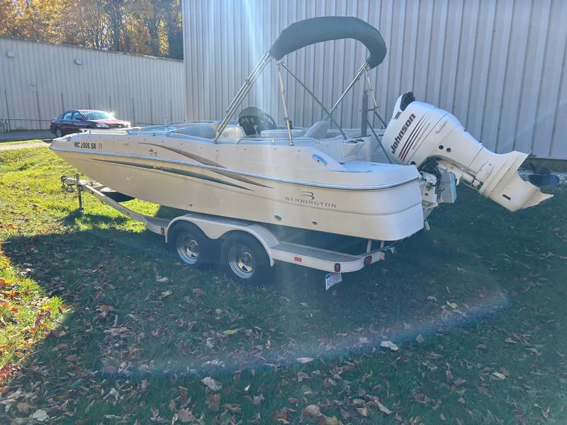 Slide: The Image of 2003 Bennington RL210 on a trailer outdoors. - 6