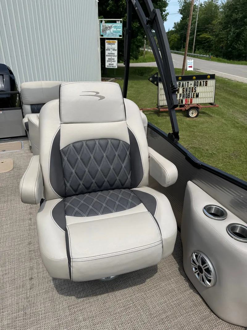 Slide: The Image of A luxurious seat on a Bennington 25RSR boat, featuring elegant stitching and cup holders. - 8