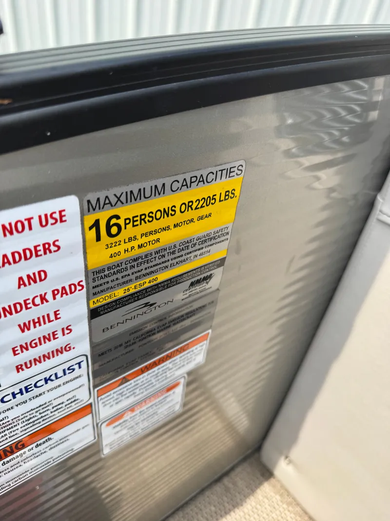 Slide: The Image of Sign on a boat with capacity information: 16 persons or 2205 pounds. - 13