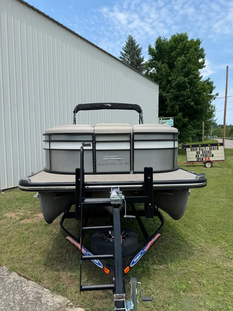 Slide: The Image of 2019 Bennington 25RSR pontoon boat on a trailer next to a building. - 5