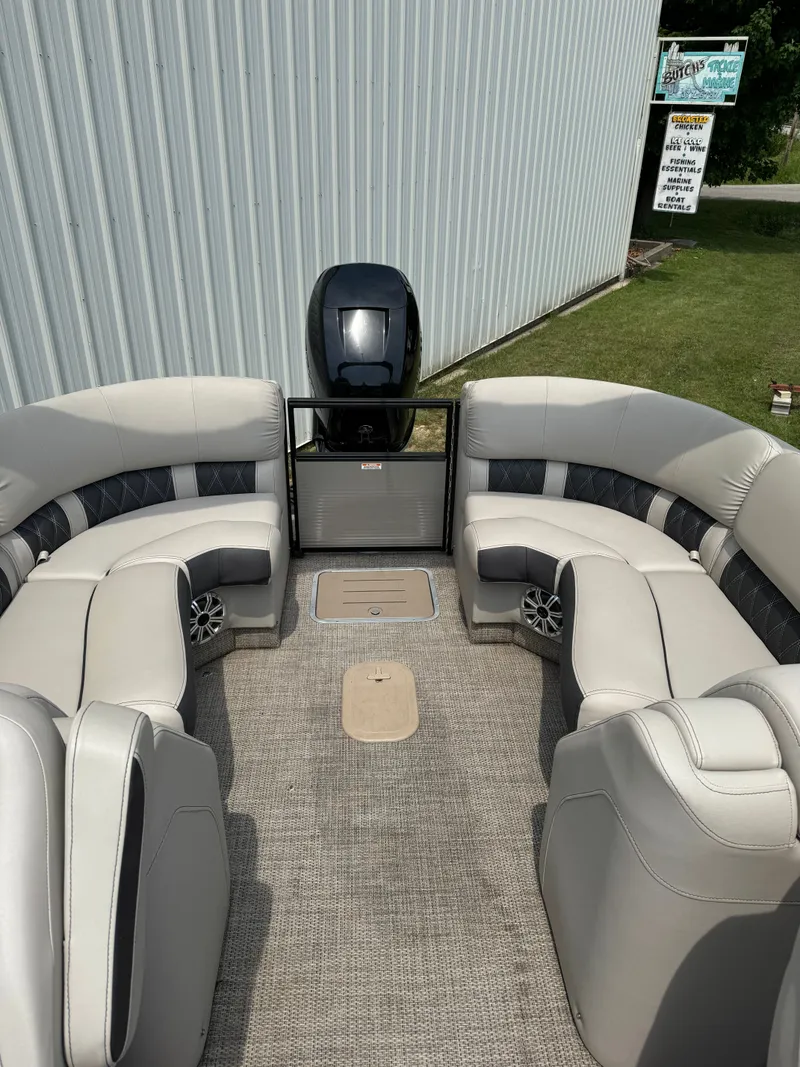 Slide: The Image of Interior of a Bennington 25RSR pontoon boat with beige and gray seating. - 11