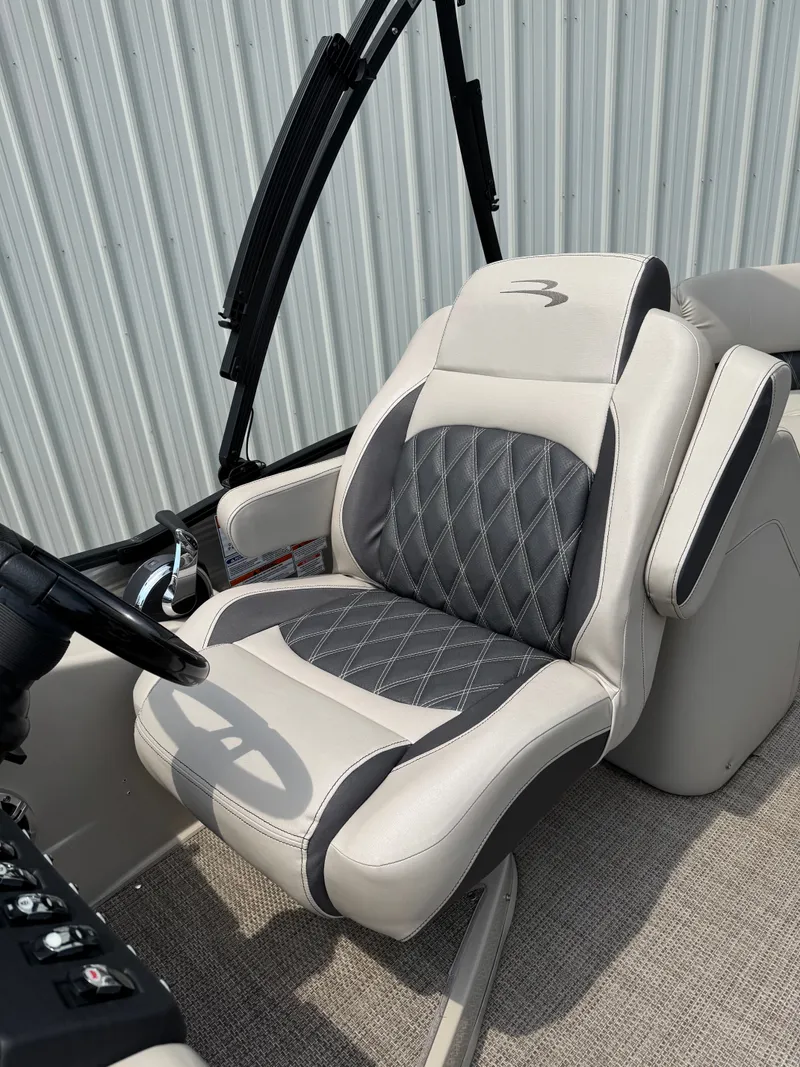 Slide: The Image of The 2019 Bennington 25RSR features a luxurious captain's chair with gray and cream upholstery. - 9