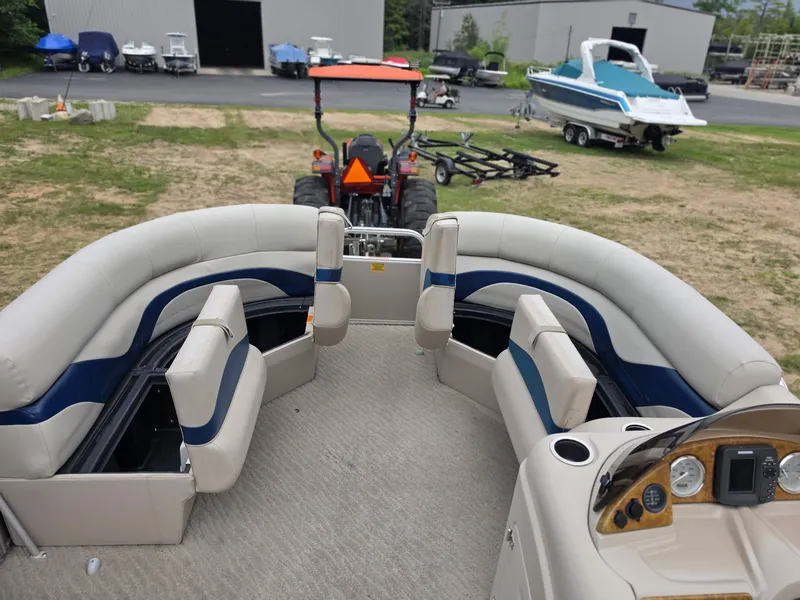 Slide: The Image of 2012 Berkshire 231RF pontoon boat with beige and blue seating, on a trailer. - 18
