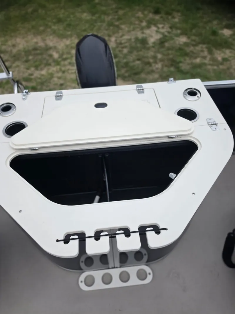 Slide: The Image of A boat with a white console and cup holders. - 13