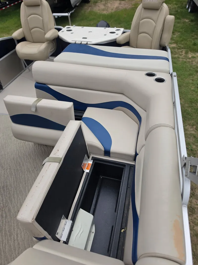 Slide: The Image of Interior of a 2012 Berkshire 231RF with beige and blue seating and storage space. - 17