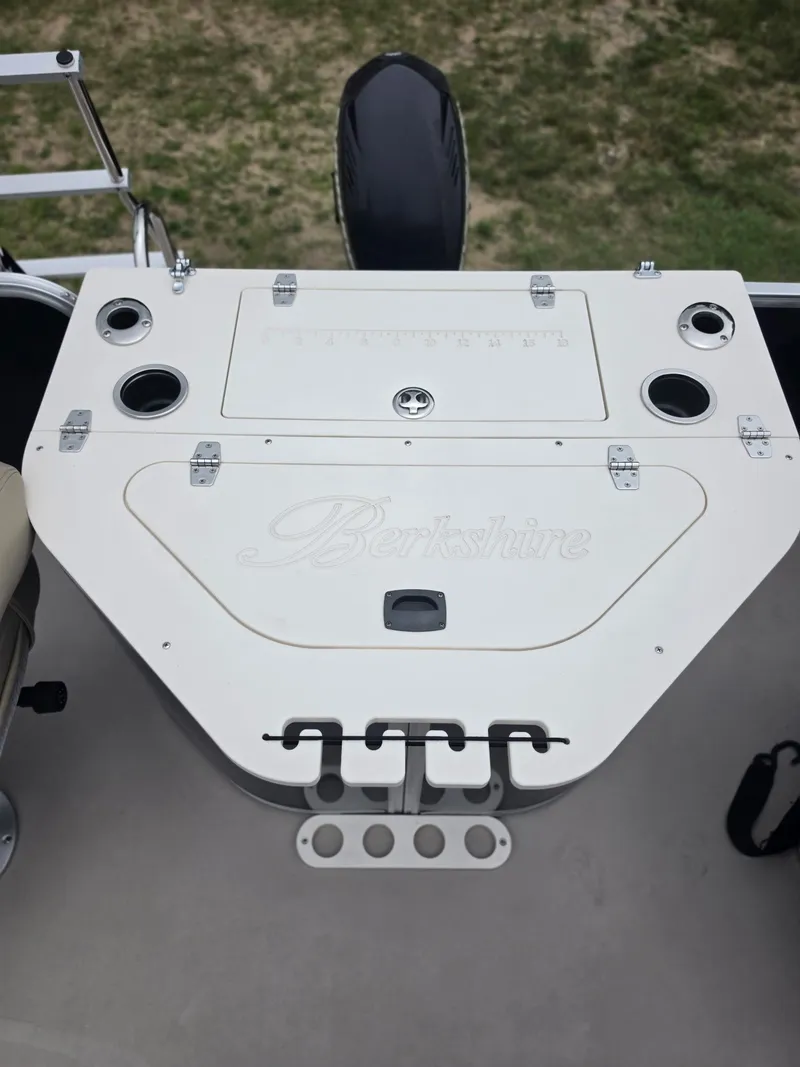 Slide: The Image of The image shows the deck of a Berkshire 231RF boat with cup holders and storage. - 12