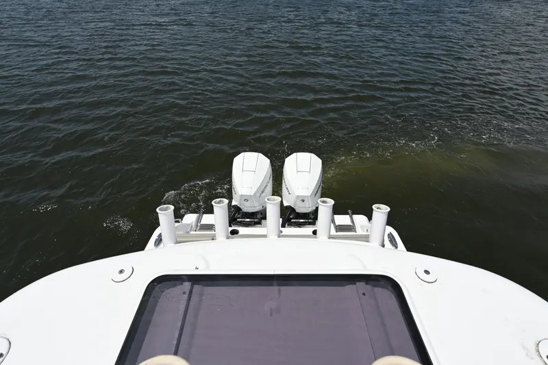 Slide: The Image of 2025 Sportsman Heritage 261 Center Console boat with dual engines on open water. - 17