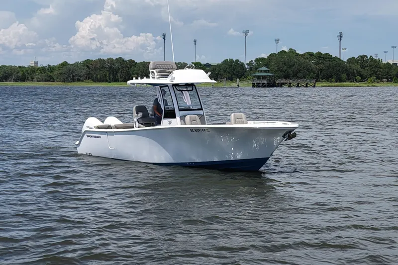 Slide: The Image of 2025 Sportsman Heritage 261 Center Console boat on calm water, with scenic background. - 4