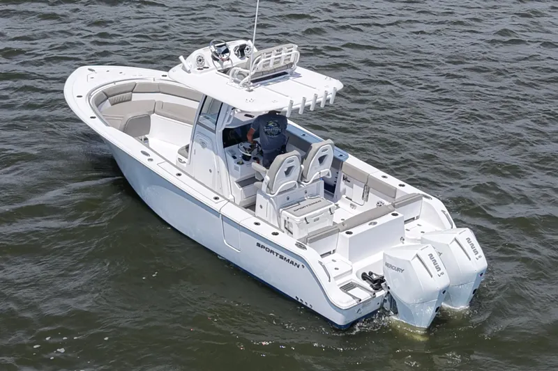 Slide: The Image of 2025 Sportsman Heritage 261 Center Console boat cruising on open water. - 1