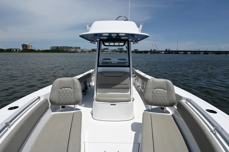 Slide: The Image of 2025 Sportsman Heritage 261 Center Console boat on calm water, showcasing seating and console. - 14