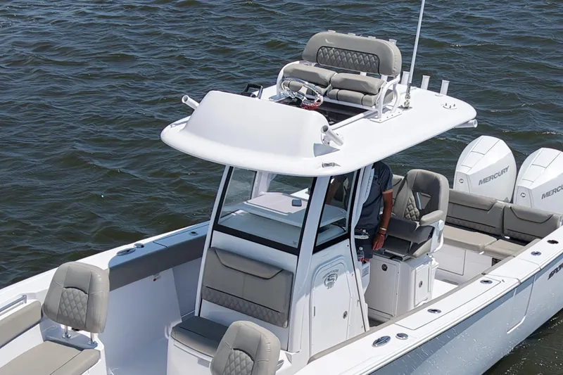 Slide: The Image of 2025 Sportsman Heritage 261 Center Console boat on water, featuring dual Mercury engines. - 3