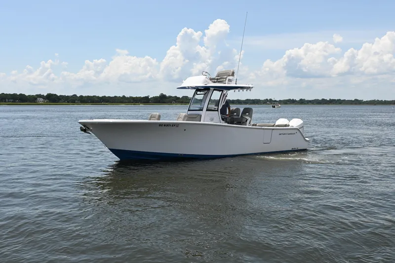 Slide: The Image of 2025 Sportsman Heritage 261 Center Console boat cruising on a calm lake. - 29