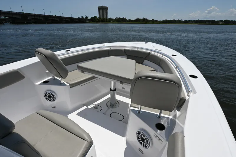 Slide: The Image of 2025 Sportsman Heritage 261 Center Console boat interior with seating and table on calm water. - 11