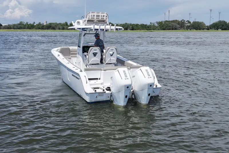 Slide: The Image of 2025 Sportsman Heritage 261 Center Console boat on water, featuring dual outboard engines. - 6