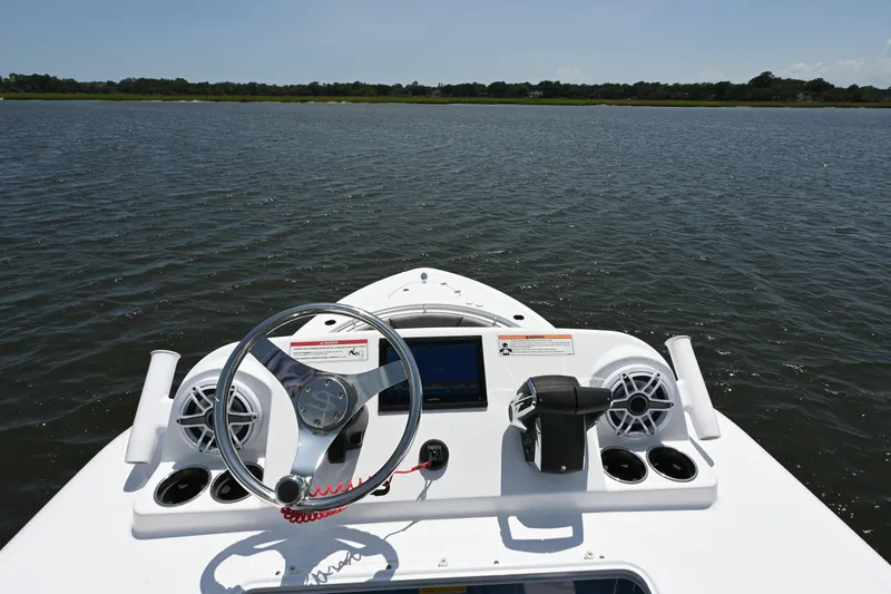 Slide: The Image of 2025 Sportsman Heritage 261 Center Console boat dashboard on open water. - 15